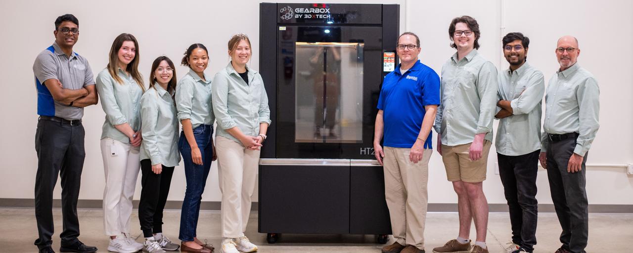 Photo of the aMDI Team by the new AM Printer